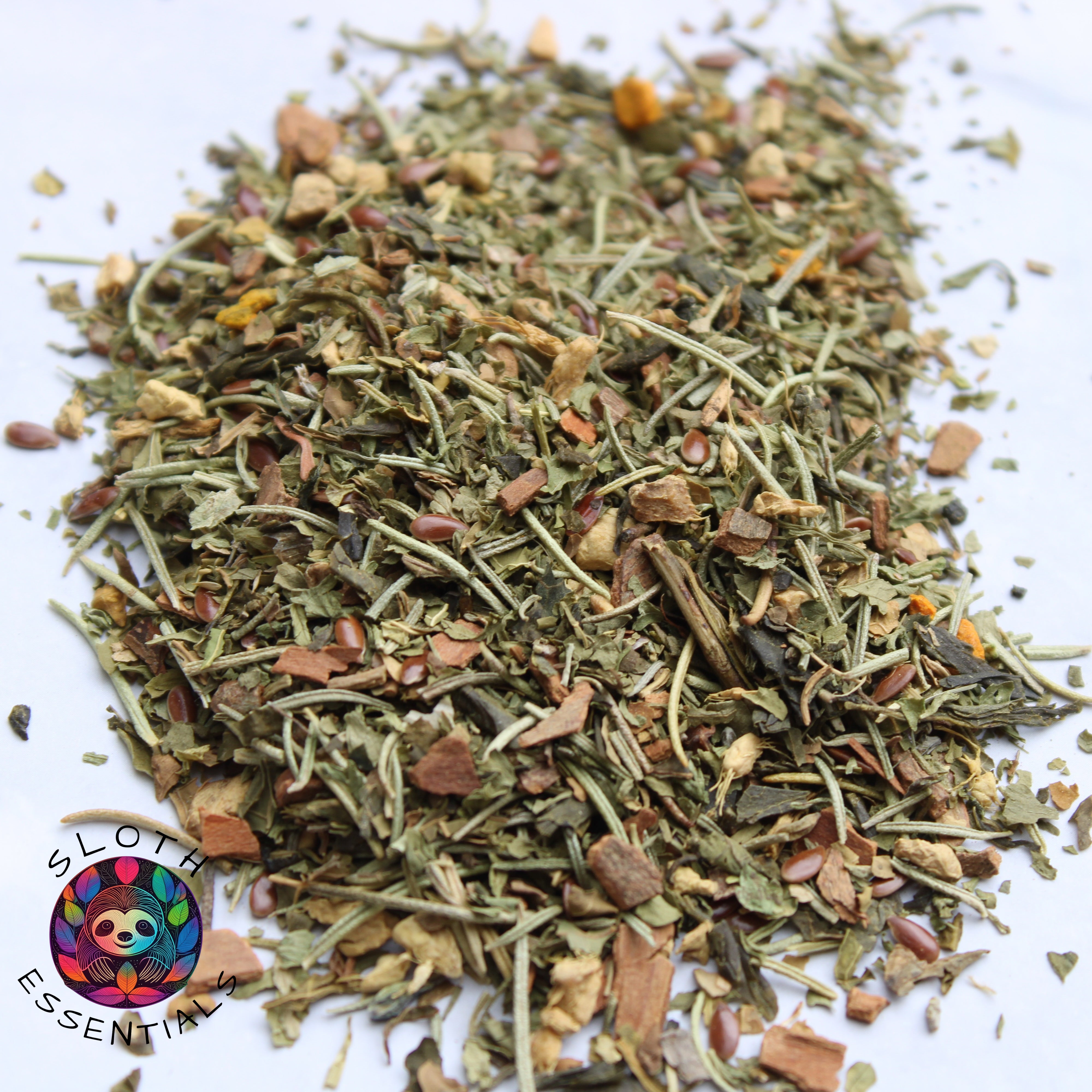 Zoomed-in photo of Focus Blend Tea showcasing ingredients like rosemary, ginger, cinnamon, parsley, papaya leaf, sencha green tea, flax seed, and turmeric.