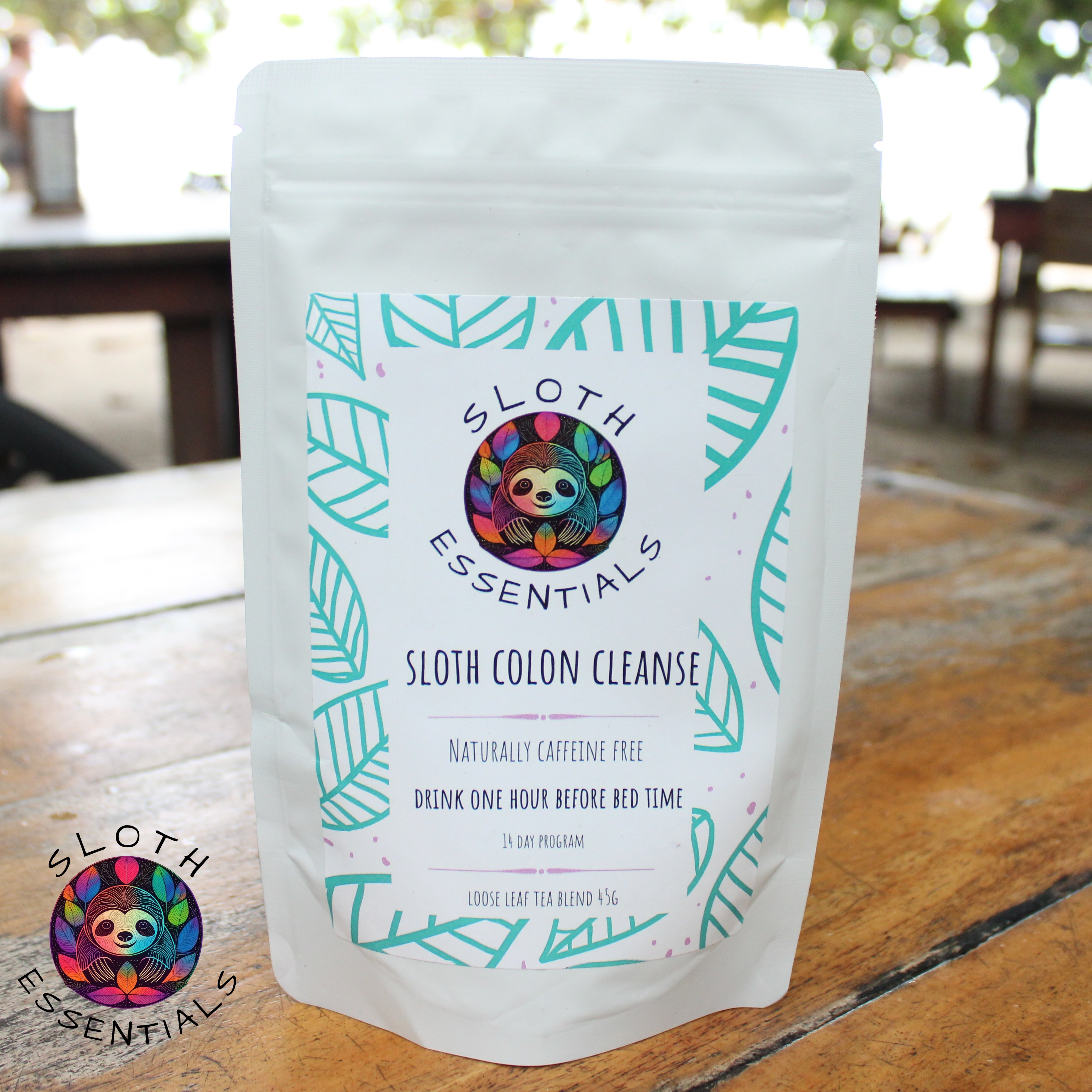 Colon Cleanse Tea packaging with a beach in the background, capturing the essence of natural wellness and tranquility.