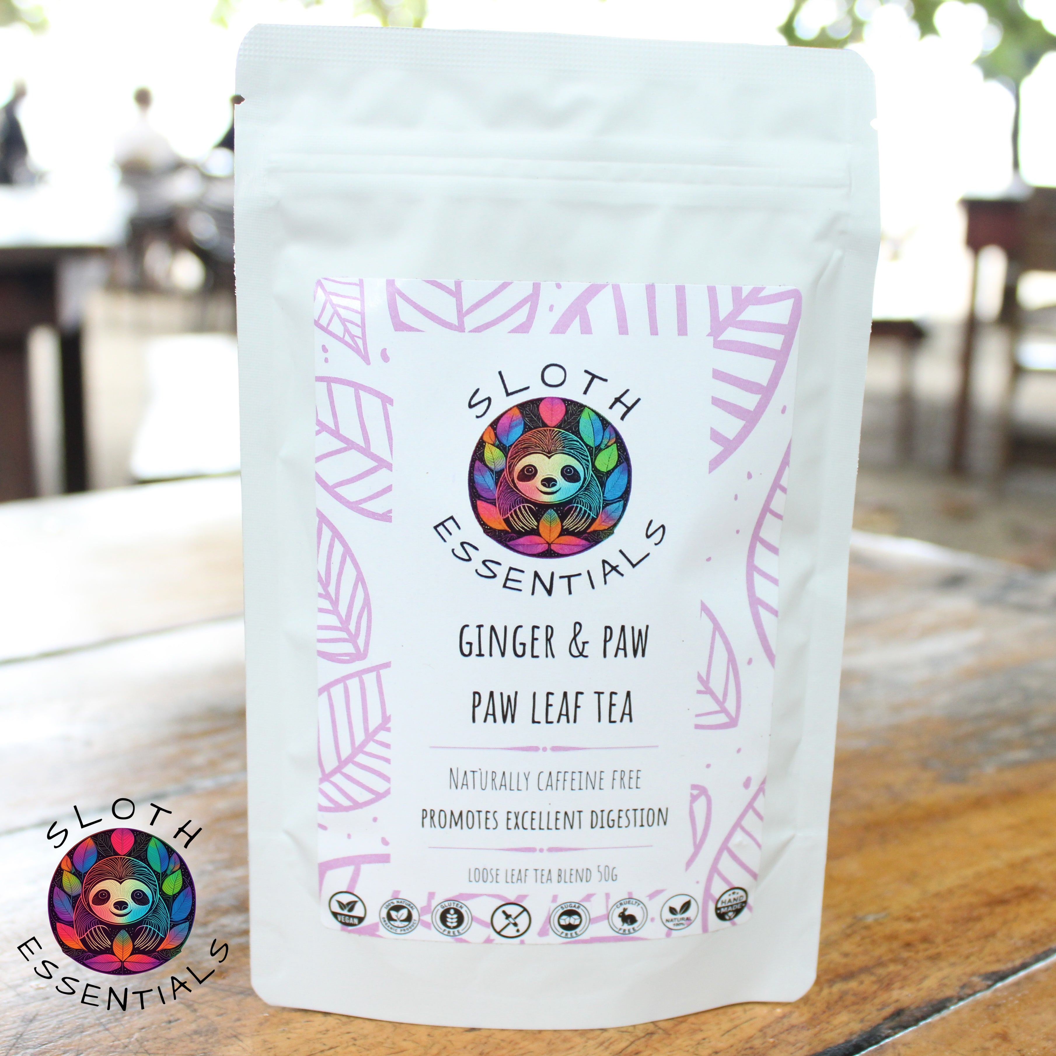 Packaging of Ginger Papaya Leaf Tea with a beach in the background, highlighting the tropical inspiration of the blend